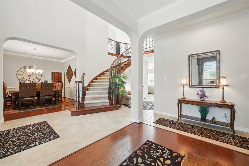 On the left side of the entrance is the formal dining room, and on the right side is the living room.