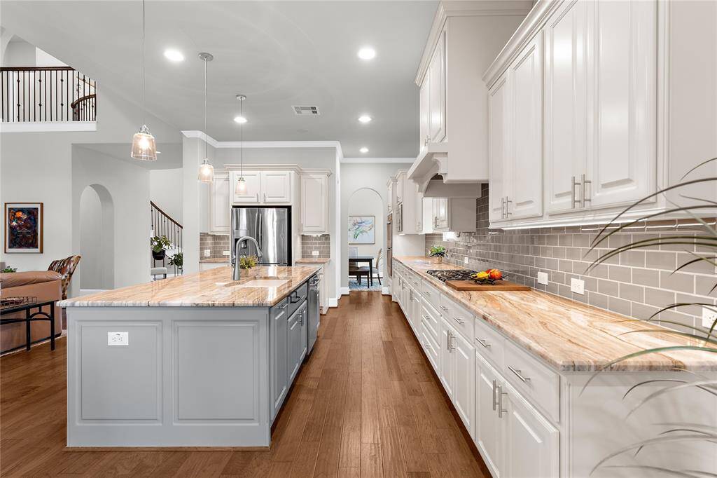 The gorgeous gray island really gives the classy kitchen a special touch.