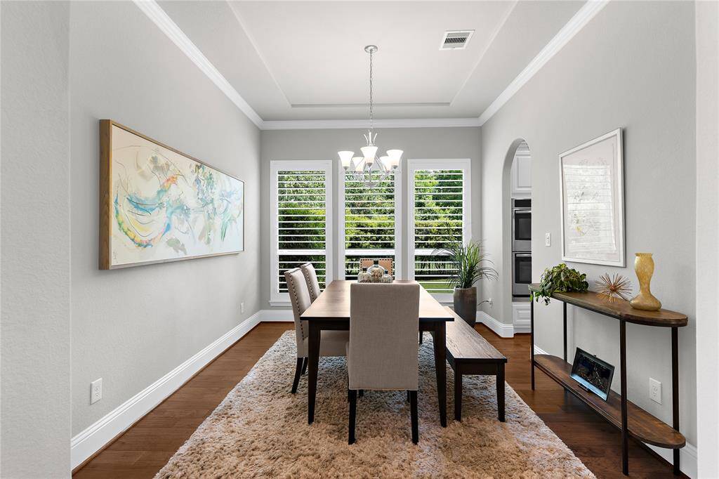 The dining room has tons of natural light peering in from the high-class plantation shutters.