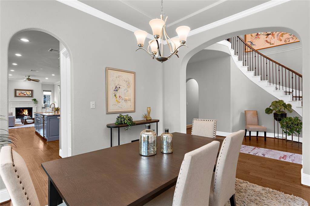 Another view of the dining room with sophisticated arch ways to the foyer and the kitchen.
