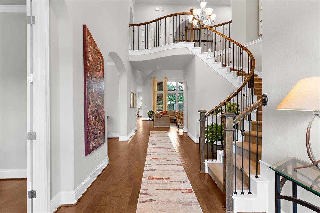 Welcome home! This elegant grand foyer shows off the beautiful arched stairway.