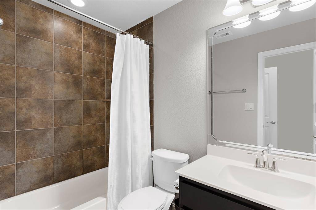 Bedroom 3 full bathroom showing off its upgraded beveled mirrors.