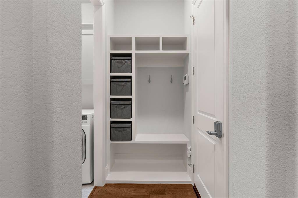 When you enter from the garage there is a convenient mudroom bench and storage area.