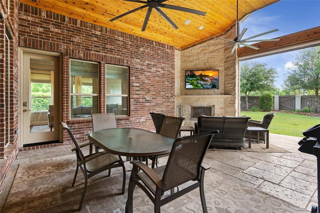 This large extended patio is a great place to enjoy dinner or gather with friends. Keep cool with two "Big Ass Fans" but also motorized patio screen controlled by remote that completely shut to the ground to keep bugs out and help with shade.