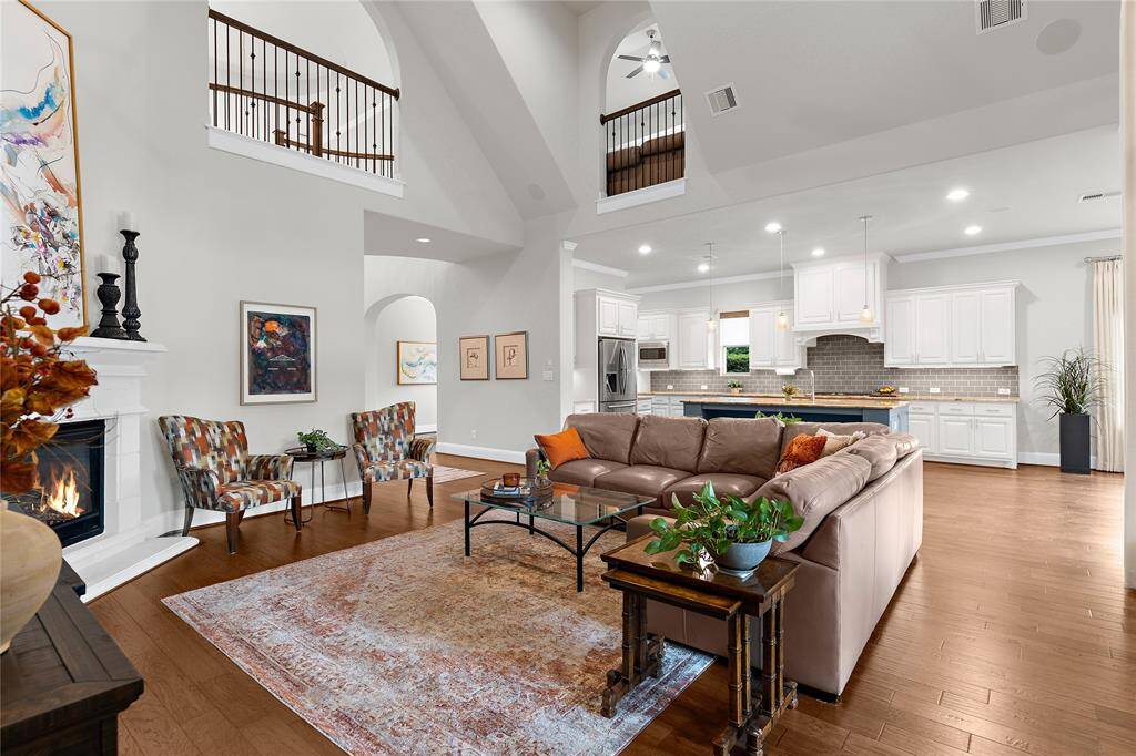 This marvelous living room has high ceilings and that wonderful open concept connecting to the gorgeous kitchen.