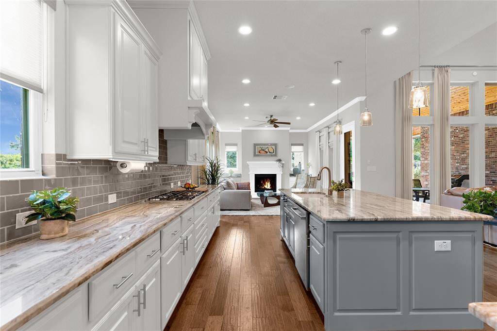 This kitchen view peers into the lovely sitting area with your second fireplace in the home.