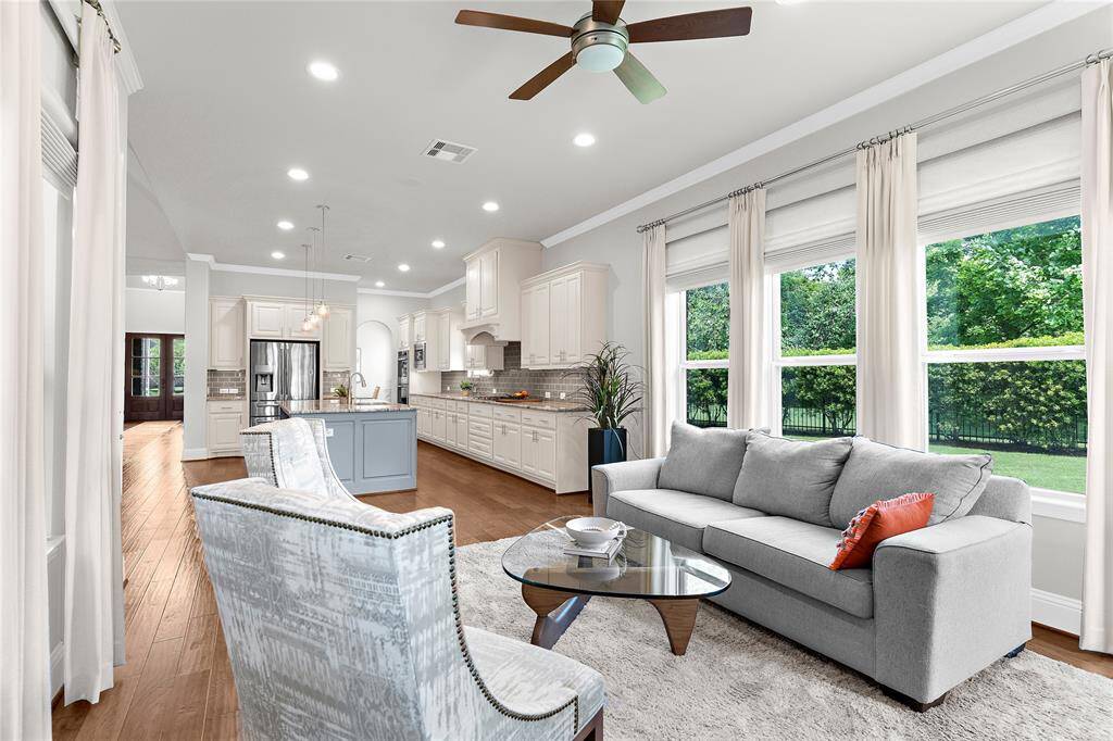 This extended flex space next to the kitchen is currently being used for another living room space but has the potential for many uses such as large kitchen table.