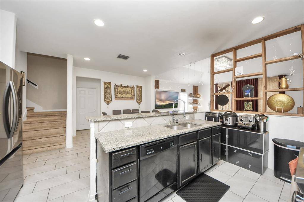 The kitchen overlooks the dining and living areas, creating an open and connected space perfect for entertaining.