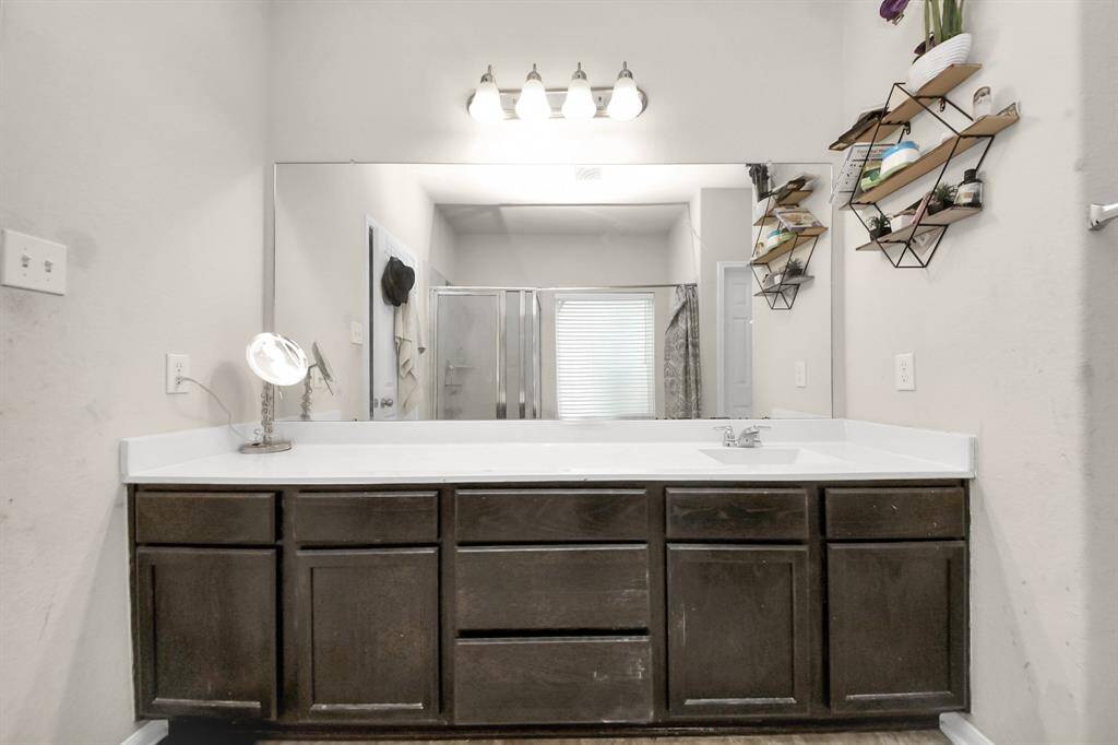 Primary bathroom features double sinks, offering plenty of space and convenience for shared use.