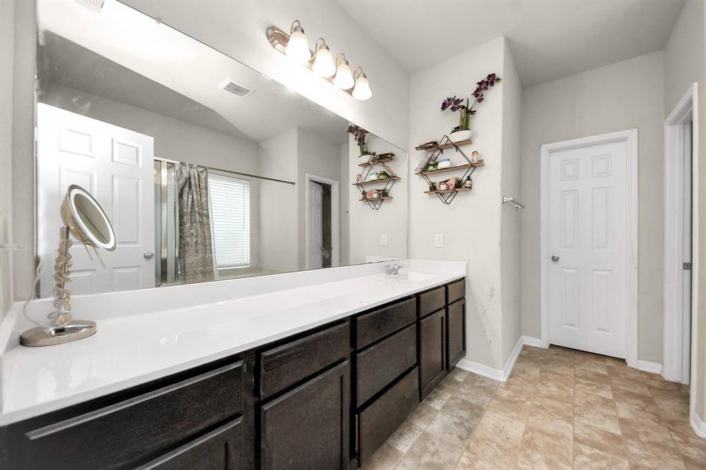 Primary bathroom includes a separate tub and shower, double sinks, and a spacious walk-in closet for ultimate comfort and convenience.