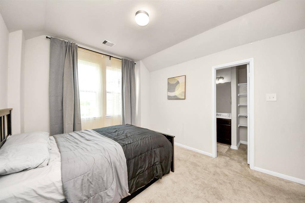 Bedroom 2 features a walk-in closet, offering ample storage.