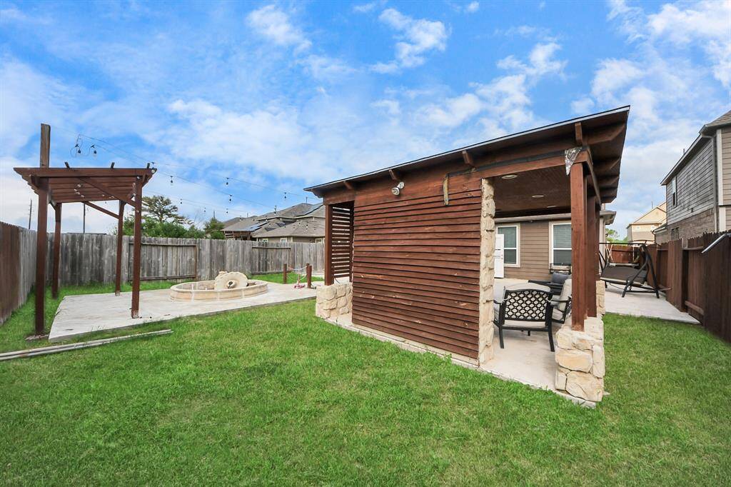 Custom-built gazebo with a cozy fireplace creates a warm and inviting ambiance, making the backyard an ideal spot for family gatherings and entertaining guests.