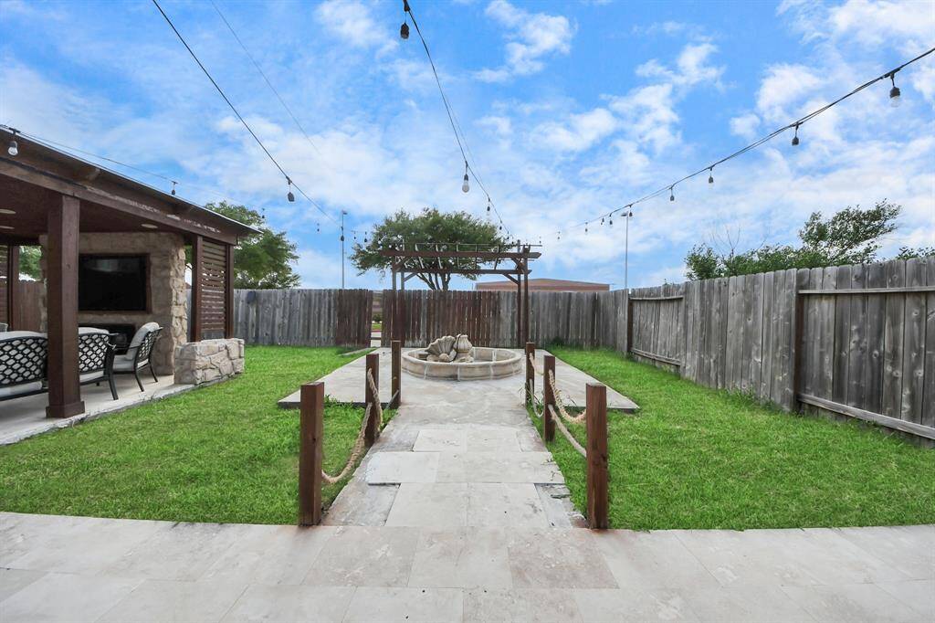 Stylish tiles to the backyard, providing easy access and low-maintenance landscaping.