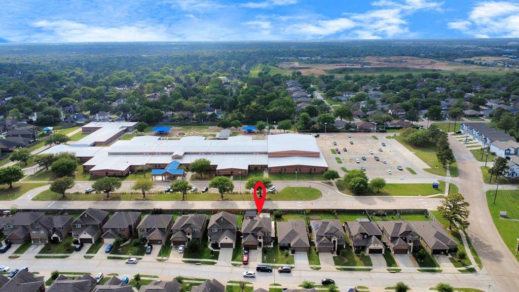 The stunning aerial view showcases the home's expansive layout, lush surroundings, and prime location.