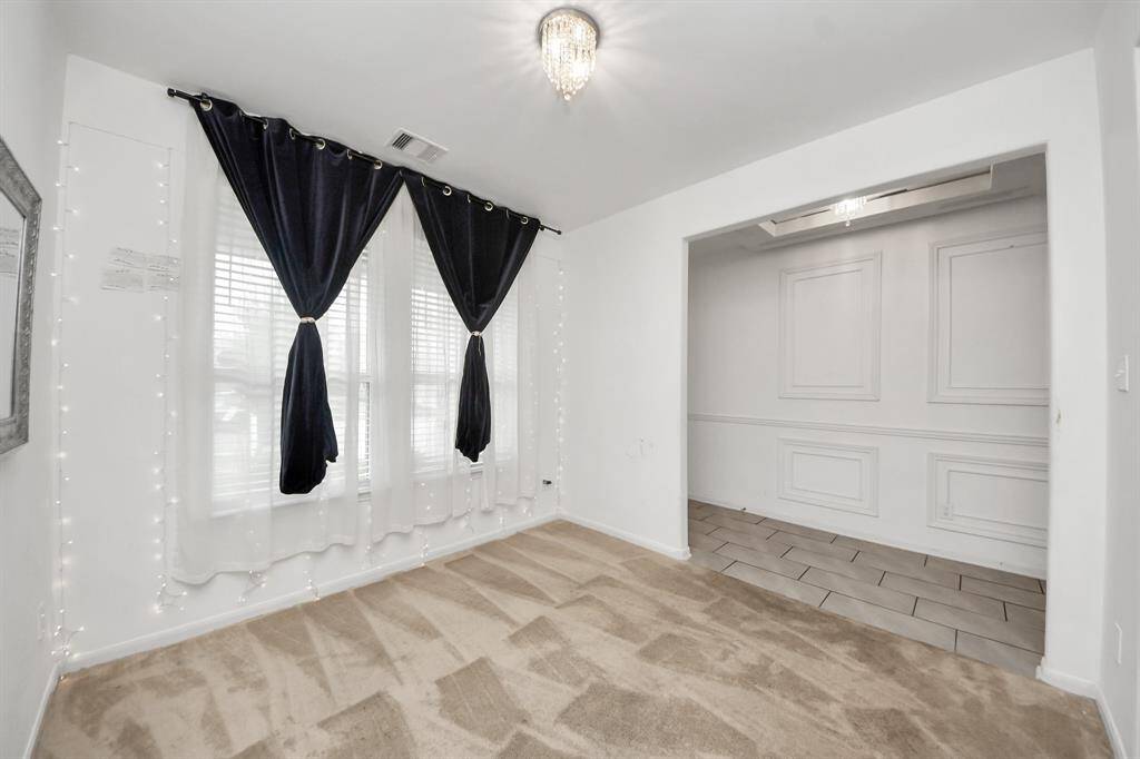 Versatile space, perfect for a home office or an elegant formal living area.