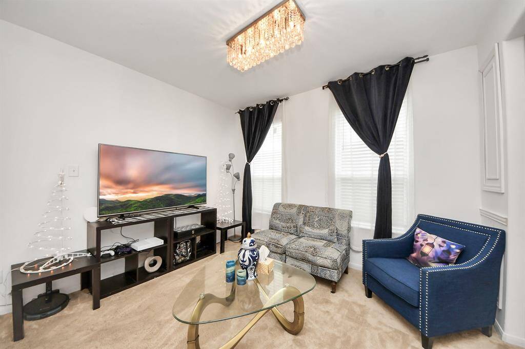The elegant formal living area offers flexibility and can easily be transformed into a sophisticated formal dining space.