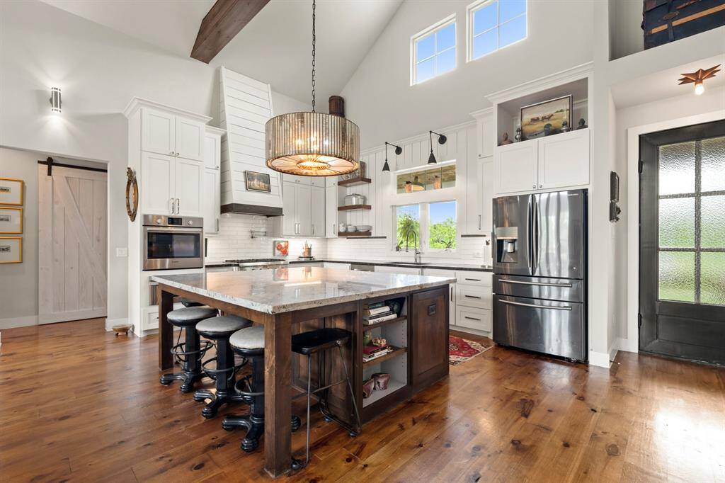 This stunning kitchen is the heart of the home, anchored by an expansive island that offers both beauty and functionality