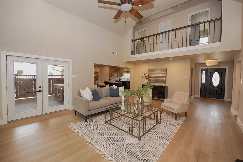 A view of the family room with French doors to the back patio and is even open all the way to the foyer as well as the kitchen.