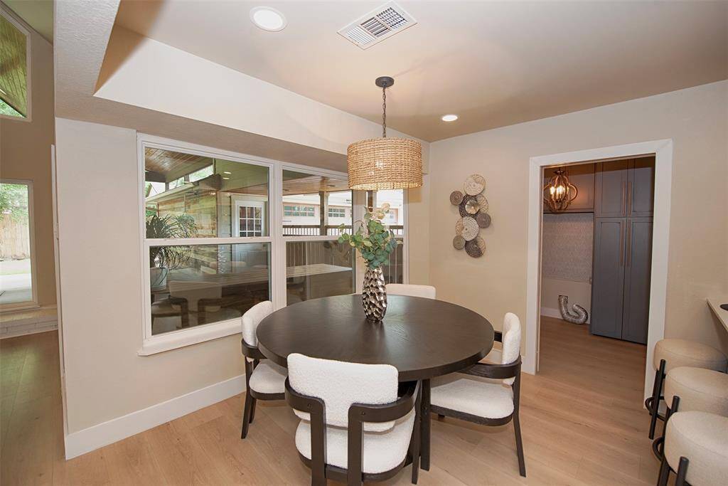 Dining area has high ceiling and great views of the back patio and outdoor entertaining space.