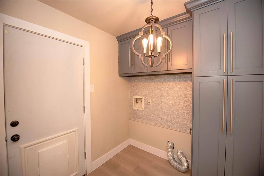Through a pocket door off of the kitchen and dining area is a great utility room with secondary door to the patio ... and even a pet door. The built in custom cabinetry is perfection for keeping all of your laundry essentials. There is even room for a vacuum and household cleaning items.