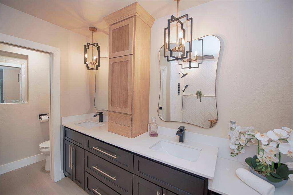 Gorgeous double vanity with white quartz counters, custom lighting and incredible storage.