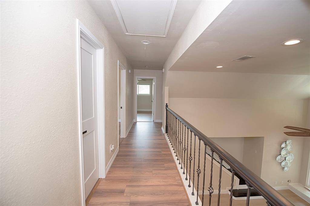 Gorgeous cat walk upstairs with wood laminate floors.