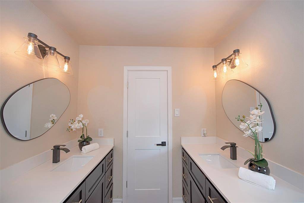 From the catwalk as well as the 3rd and 4th bedroom is an updated bathroom with separate sinks, updated lighting and mirrors. Perfect for sharing.