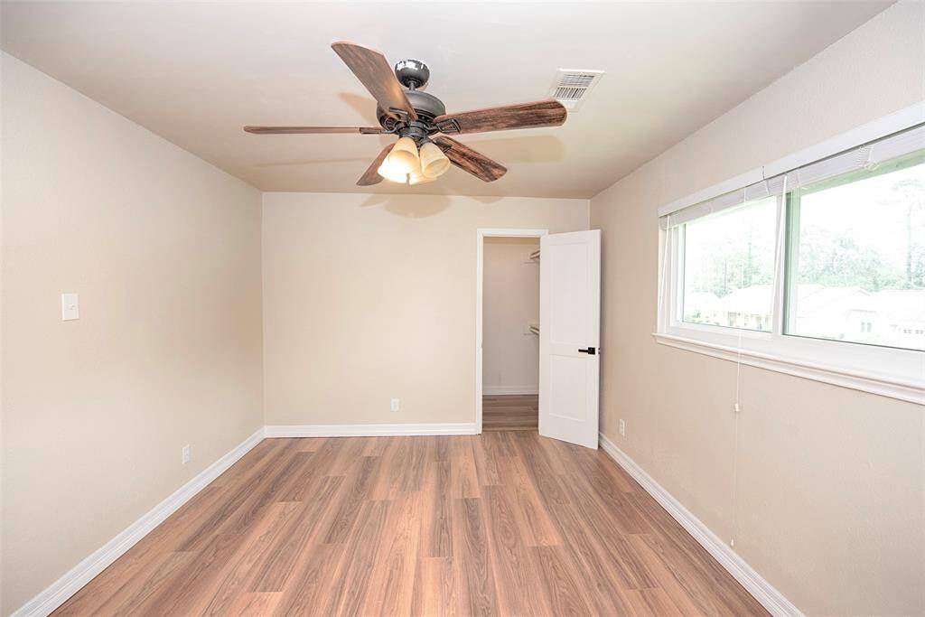 Room provides a walk in closet as well.  This room also provides a secondary door which has attic storage space.