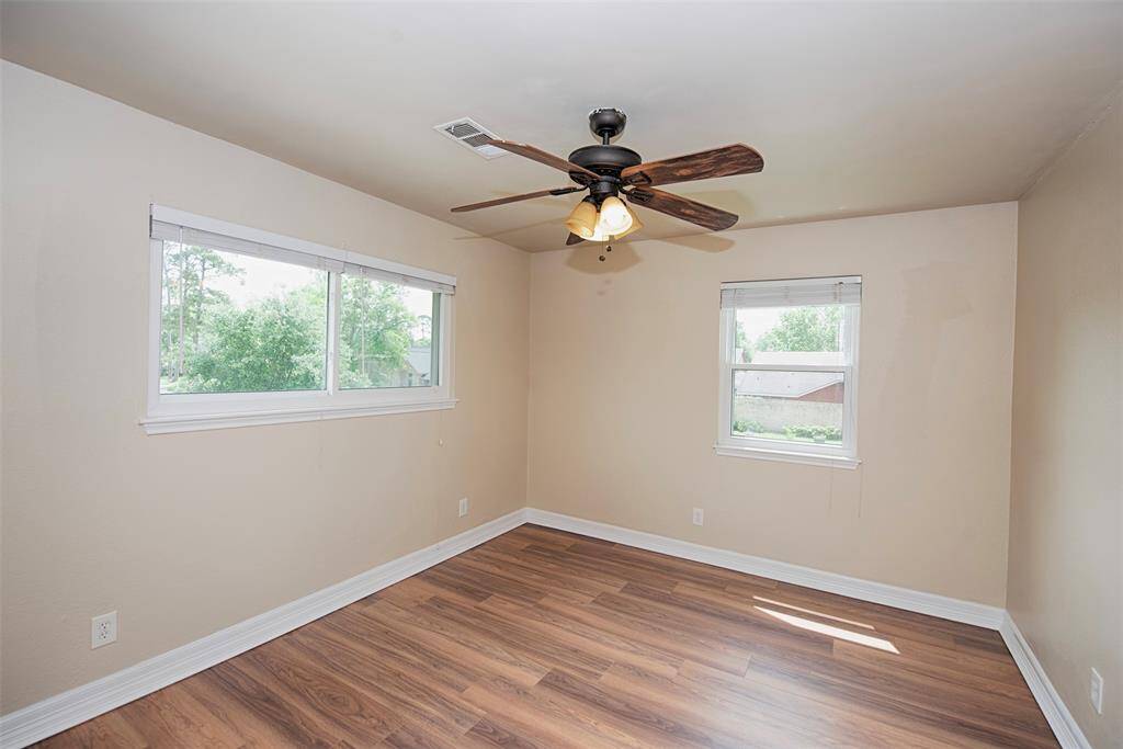 Another fabulous and very spacious bedroom with two walls of windows providing great natural light.