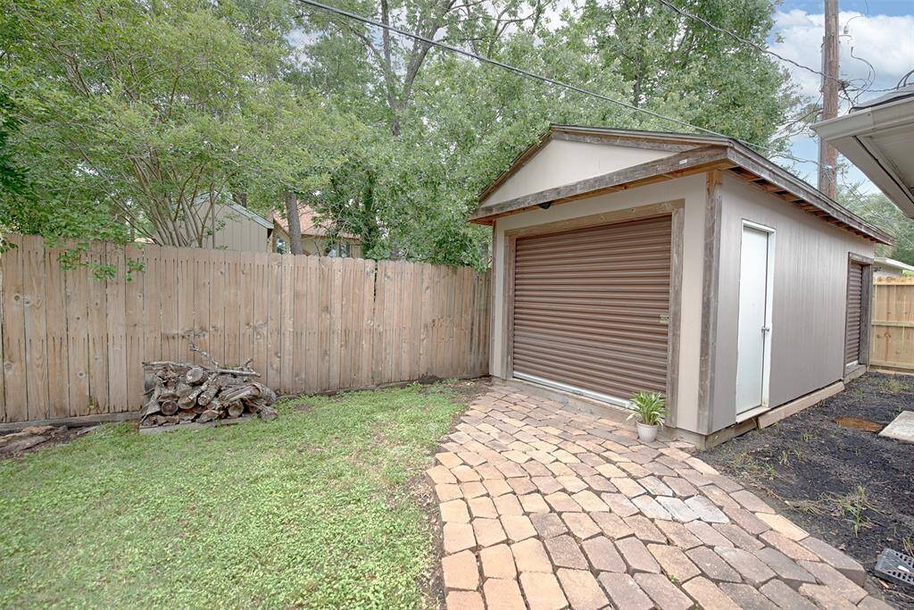 Off of the patio is a paved brick walkway to an additional shed. Perfect for storing your landscaping tools. Might also be a great spot for a workshop.