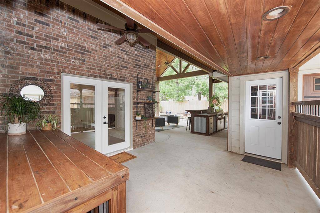 Back patio from the utility room to the garage and patio. Also updated with stunning ceiling woodwork.
