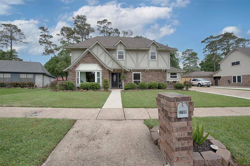 A street view of the home with mail box and even a stone accented garden surrounding it.