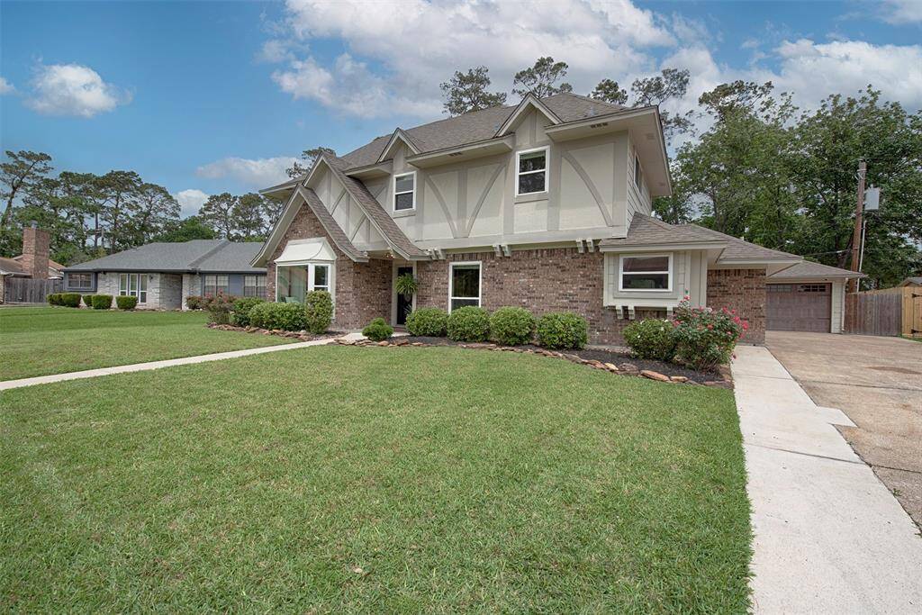 A view along the side of the home showing the lush landscaping and great curb appeal.
