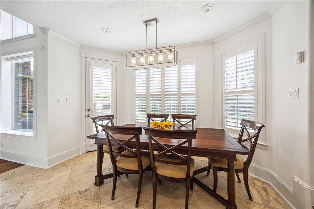 Breakfast area open to kitchen with access and views to patio, backyard and pool.