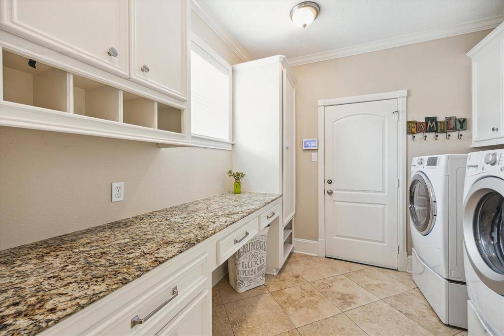Laundry room with access from garage offers built-ins creating the perfect "drop spot".