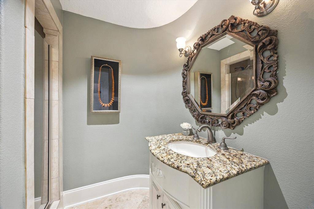 Second Full bath on 1st floor with shower and custom sink with granite countertop.