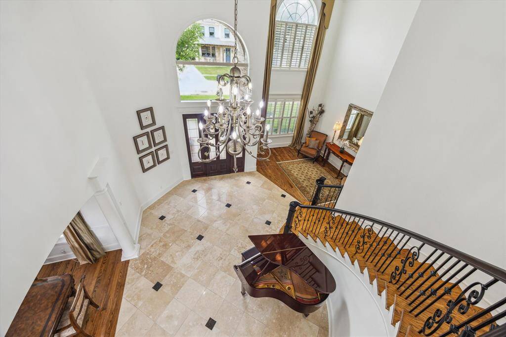 View from 2nd floor landing to entry, living room and dining.