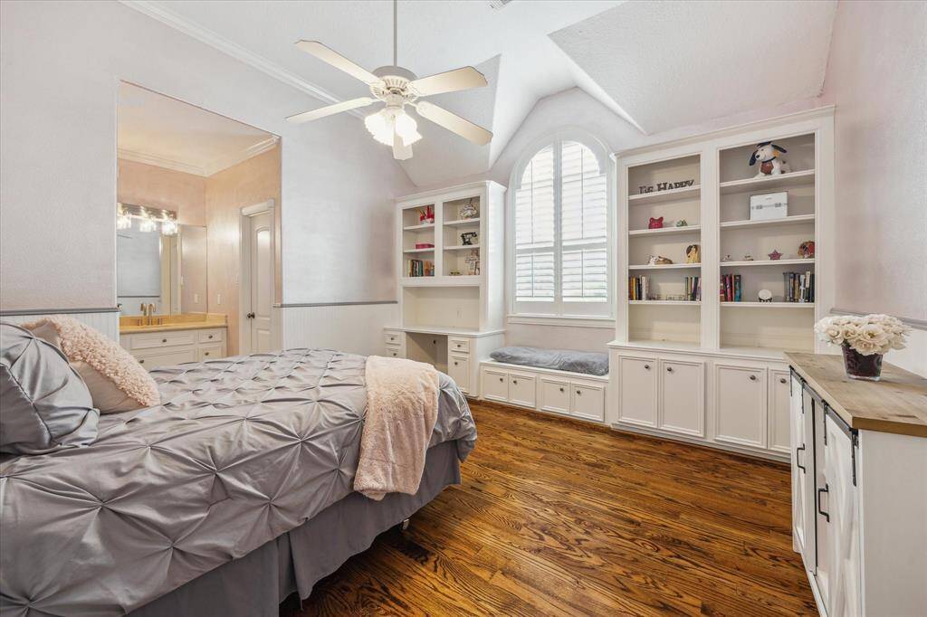 3rd bedroom with built-in desk and shelving, arched window seating. Separate vanity to Hollywood bath shared with 2nd bedroom.