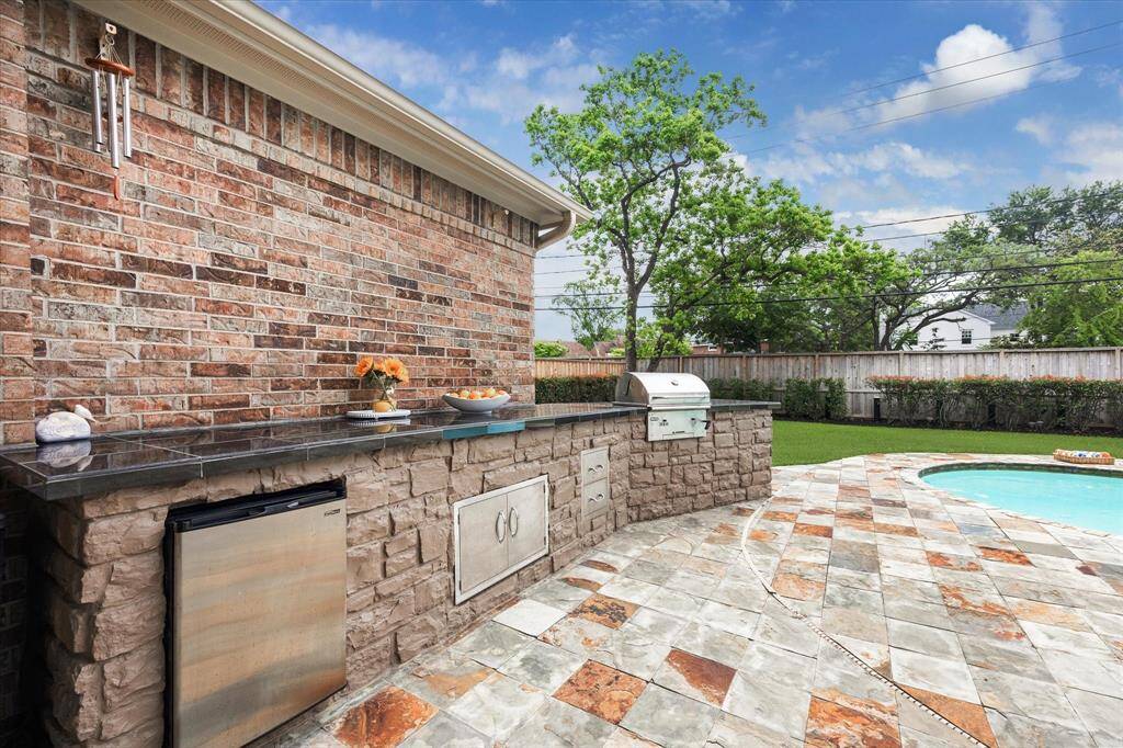 Custom Summer Kitchen with ample counter space for prep and serving.