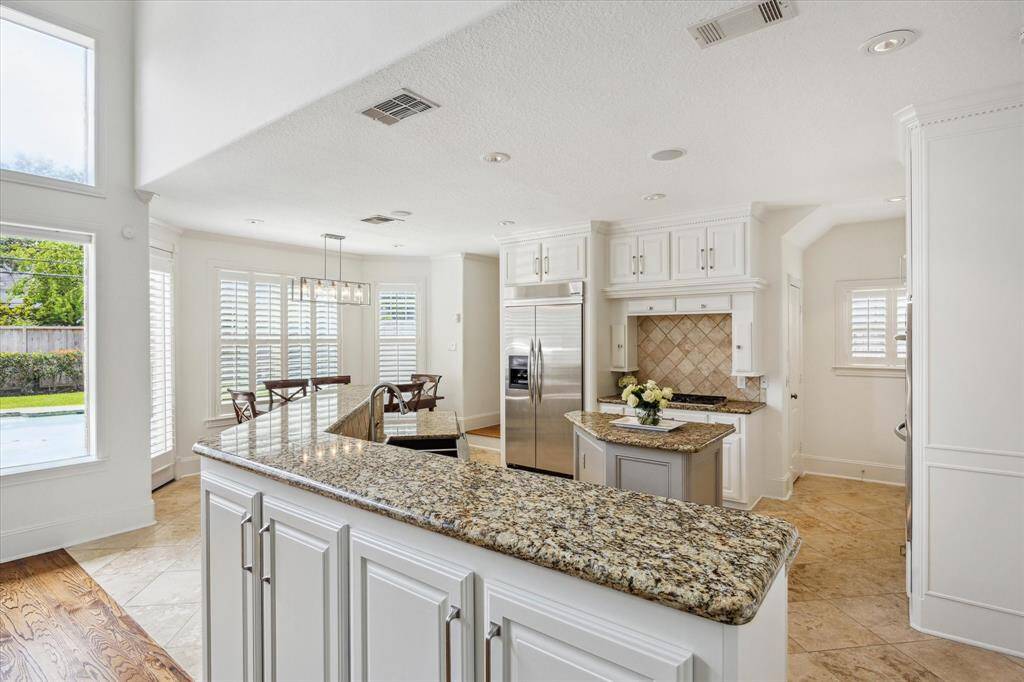 Fabulous kitchen with granite serving counter, island, butler's pantry, and walk-in pantry, open to breakfast area.