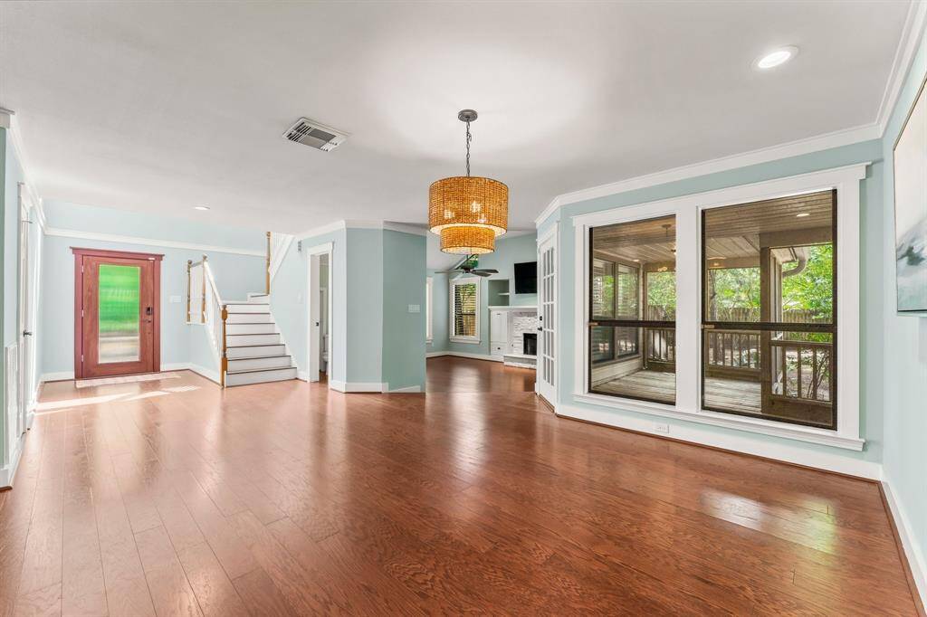 View from the dining area at the center of the home. You can see the sunken living room and the screened outdoor living space.