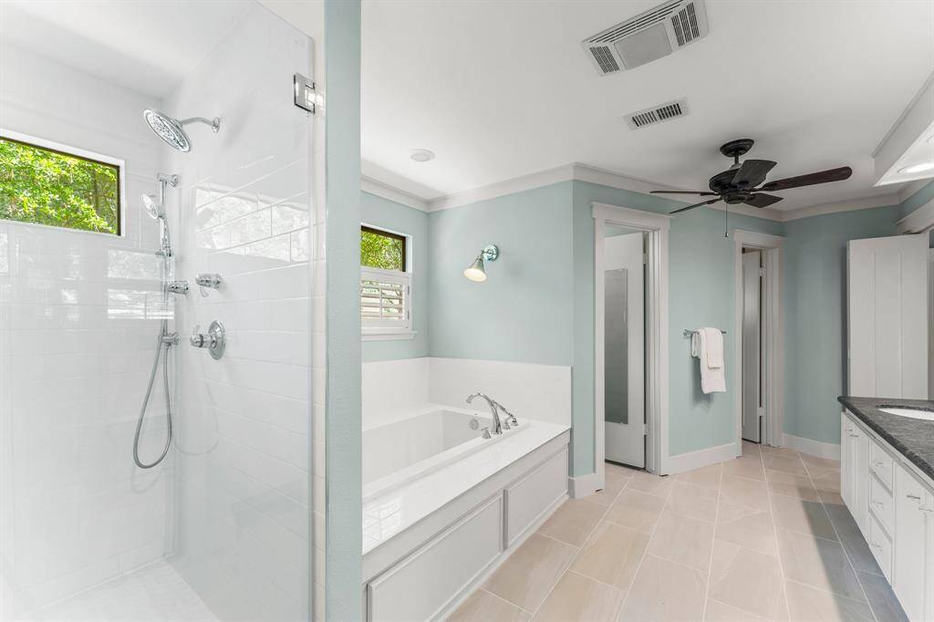Large shower has multiple shower heads for a spa like experience.