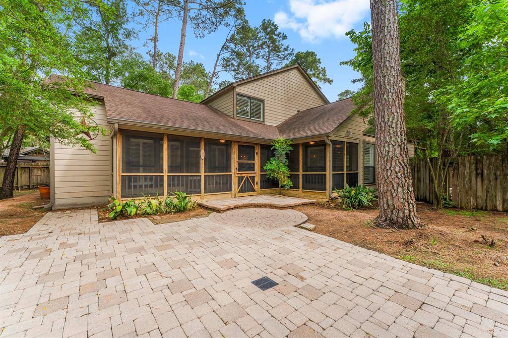 Large screened in patio leads to the expansive back yard and pool.