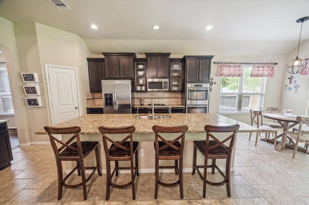 Designed for effortless entertaining, this open floor plan keeps everyone connected. An oversized bar seamlessly bridges the kitchen and family room, ideal for serving drinks and snacks, or add barstools to create a casual dining space your guests will love.