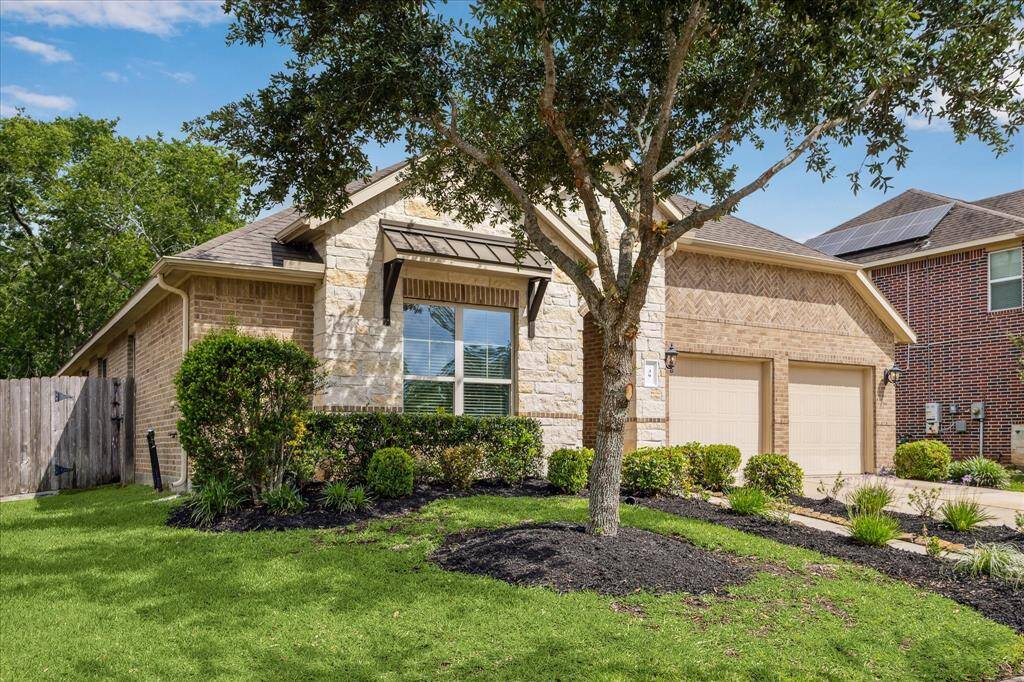 You’ll receive a warm welcome home every time with outstanding curb appeal, featuring a traditional brick and stone elevation, an impressive covered entry, mature landscaping, and a full sprinkler system to keep everything looking its best. All while an oversized two-car garage and double-wide driveway provide ample off-street parking for you and your guests.