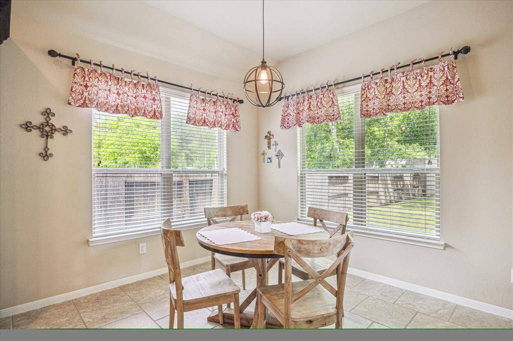 Enjoy morning coffee with a view! This lovely breakfast area is filled with soft natural light and offers a warm, welcoming space to start your day with peaceful backyard views.