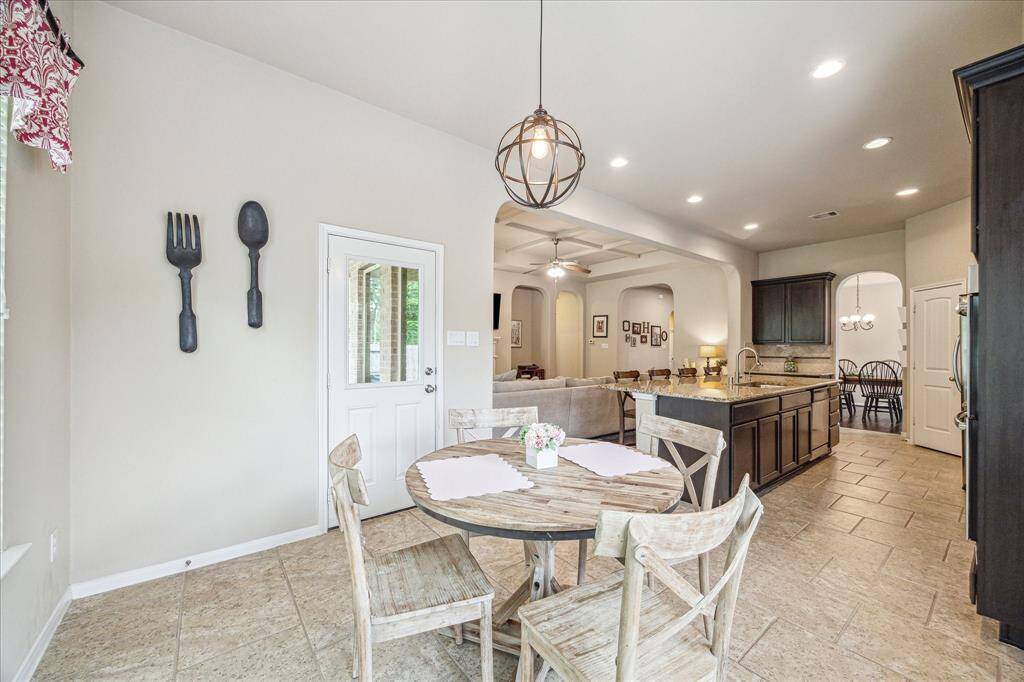 Enjoy Wednesday night lasagna or Saturday morning pancakes in this casual dining area with a stylish chandelier and plenty of room for your breakfast table.
