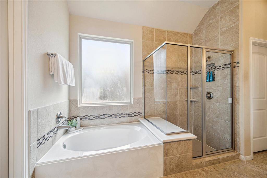 Relax and soak your worries away in this luxurious soaking tub or enjoy a quick rinse in the spacious walk-in shower. Either way, you'll love this private retreat.