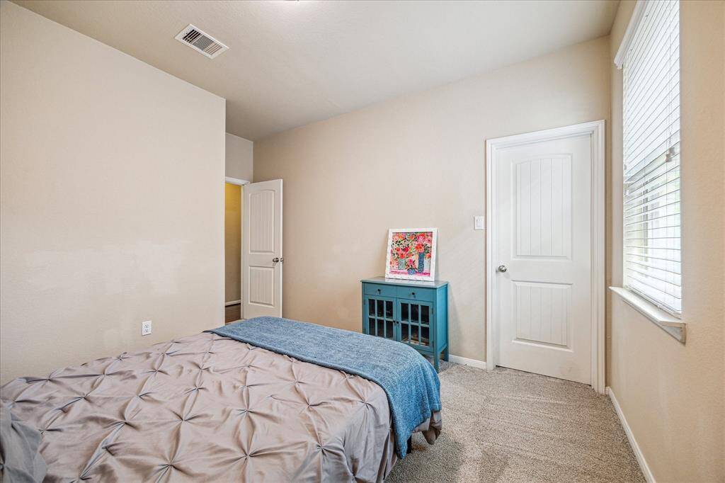 This roomy guest room offers recent carpet, neutral paint, a large closet and easy access to a full bathroom.