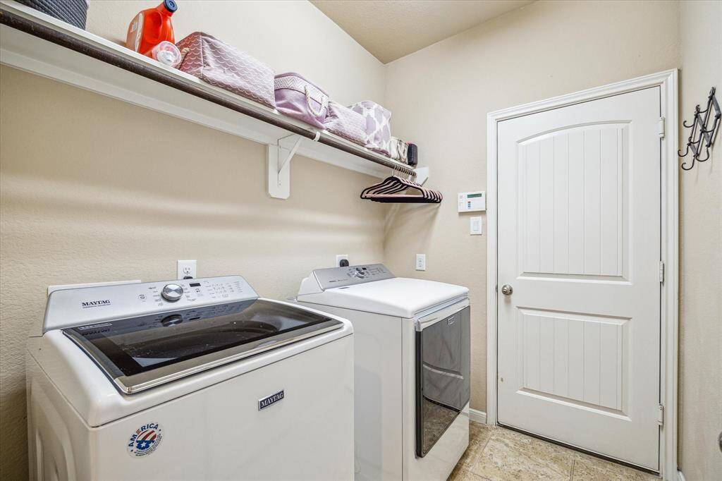 The utility room offers durable tile flooring, a closet, full shelf for household storage, a hanging bar for clothes, and plenty of space for your washer and dryer. While you're here, don't miss the home's impressive energy-efficient features, including high efficiency HVAC, a digital programmable thermostat with zoned A/C for the primary suite, Energy Star appliances and lighting, insulated doors and windows, and a radiant attic barrier all designed to enhance comfort and reduce energy costs.